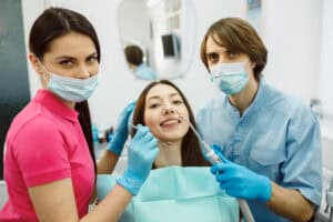 dentists with a female patient for cosmetic treatment