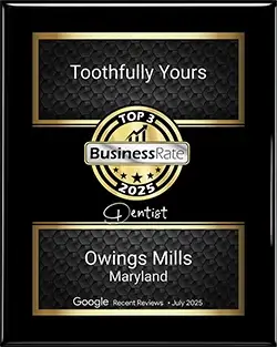 Award plaque for Toothfully Yours, recognized as a top dentist in Owings Mills, Maryland, featuring the BusinessRate logo and a 2025 designation.