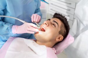 Dentist performing a dental cleaning procedure on a patient in a dental office